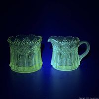 creamer and sugar bowl glowing green under UV light
