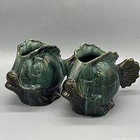 Pair of fish-shaped glazed ceramic vases showing overall shape and glaze