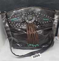 Front view showing stud, bead and fringe details and strap