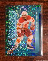 Front of the 2024-25 Blue Dazzlers MacKenzie Weegar card in protective sleeve