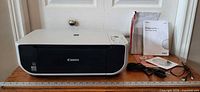 Canon PIXMA MP190 printer with accessories laid out: cables, guide, CD