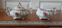 Sugar bowl and creamer set front view with ruler for scale