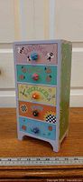 Front angled view of painted 5-drawer wooden jewelry dresser