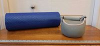 Overall view of kettlebell and foam roller with ruler for scale