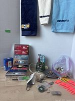 Full lot view showing towels, boxed balls, tees, keychains, coaster