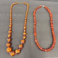 Both necklaces laid flat showing overall style and colour