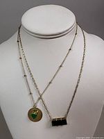 Both necklaces displayed on bust showing pendants and chain styles