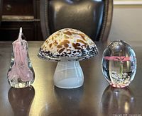 All three paperweights displayed side by side