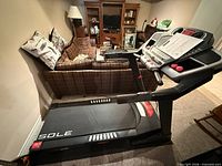 Full side view of Sole F63 treadmill showing deck, frame, and console