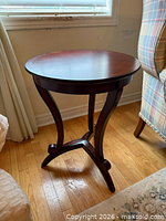 Full view of round dark cherry accent table