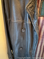 Close-up of front left side showing leather texture and two rows of buttons