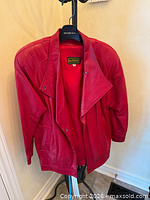 Front view of red leather Danier jacket on hanger