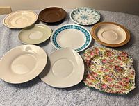 Front view of all nine assorted saucers and plates