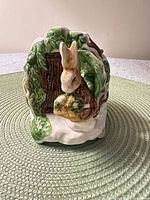 Front view showing Peter Rabbit figure at tree entrance
