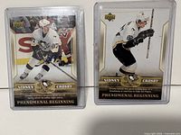Front view of both Sidney Crosby Upper Deck Phenomenal Beginning cards in cases