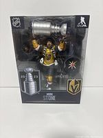 Front view of boxed Mark Stone action figure with Stanley Cup accessory visible
