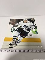 Front view of signed Phil Kessel 11x14 photo with ruler for scale