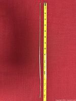 Full view of 16 inch sterling silver snake chain beside measuring tape