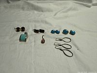 Overview of all jewelry pieces laid out on white cloth