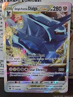Front of Origin Forme Dialga VSTAR card showing holographic artwork and stats