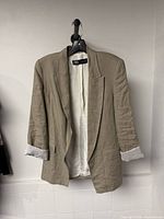 Front view of beige Zara blazer on hanger