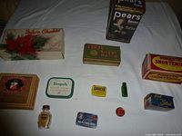 Overview of all twelve vintage containers laid out on table