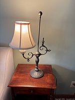 Full view of lamp with shade on wooden table