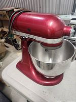 Front view of red KitchenAid stand mixer with bowl attached