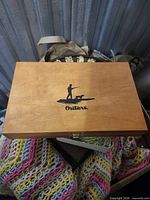 closed wood box with Outers logo on lid