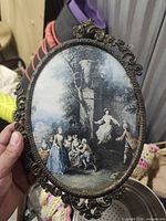 Front view showing pastoral print and ornate metal frame