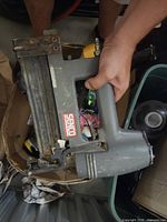 Left side view of Senco pneumatic stapler / brad nailer showing logo, handle and magazine