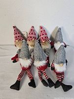 Six plush gnomes grouped showing hat variations and size