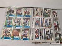 overview of multiple nine-pocket sheets filled with football cards