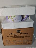 Box, foam inserts, glimpse of lavender tea set