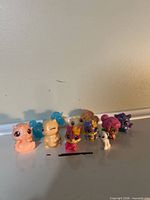 Front view of nine Little Live Pets figures