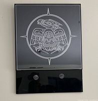 Full view of etched Raven plexiglas artwork on wall