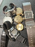 All seven watches grouped together displaying variety and condition