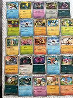 All 25 sleeved Pokémon cards laid out in a 5×5 grid, frontal view