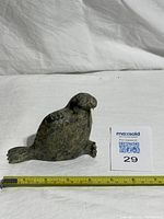 Front view of soapstone walrus showing single tusk and scale