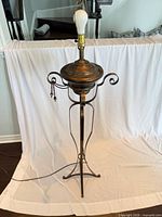 Full view of bronze metal floor lamp showing overall form and height