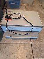 Top view of printer with power cable placed on lid