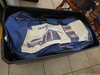 Tent packed in carry bag inside storage bin