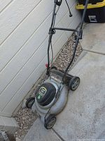Full view of Task Force corded electric mower showing deck, wheels and handle