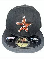 Front view of black Houston Astros fitted cap showing embroidered H-star logo and size sticker 7 1/4.