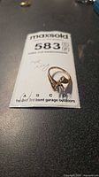 Ring on lot card showing overall design and 14K stamp location