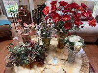 All five floral arrangements displayed on table