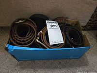 Shoebox containing multiple rolled belts
