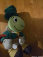 Front angled view of Jiminy Cricket plush