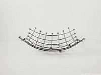side view of curved chrome grid fruit basket on ball feet