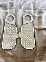 Pair of gray plastic organizer panels joined at center